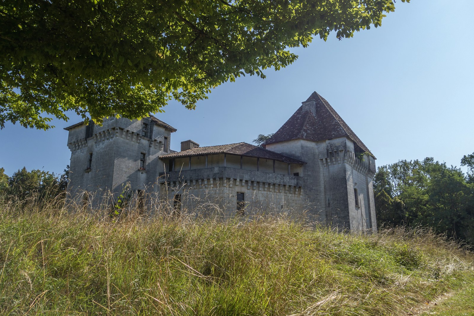 an old building with a tower on top of a hill